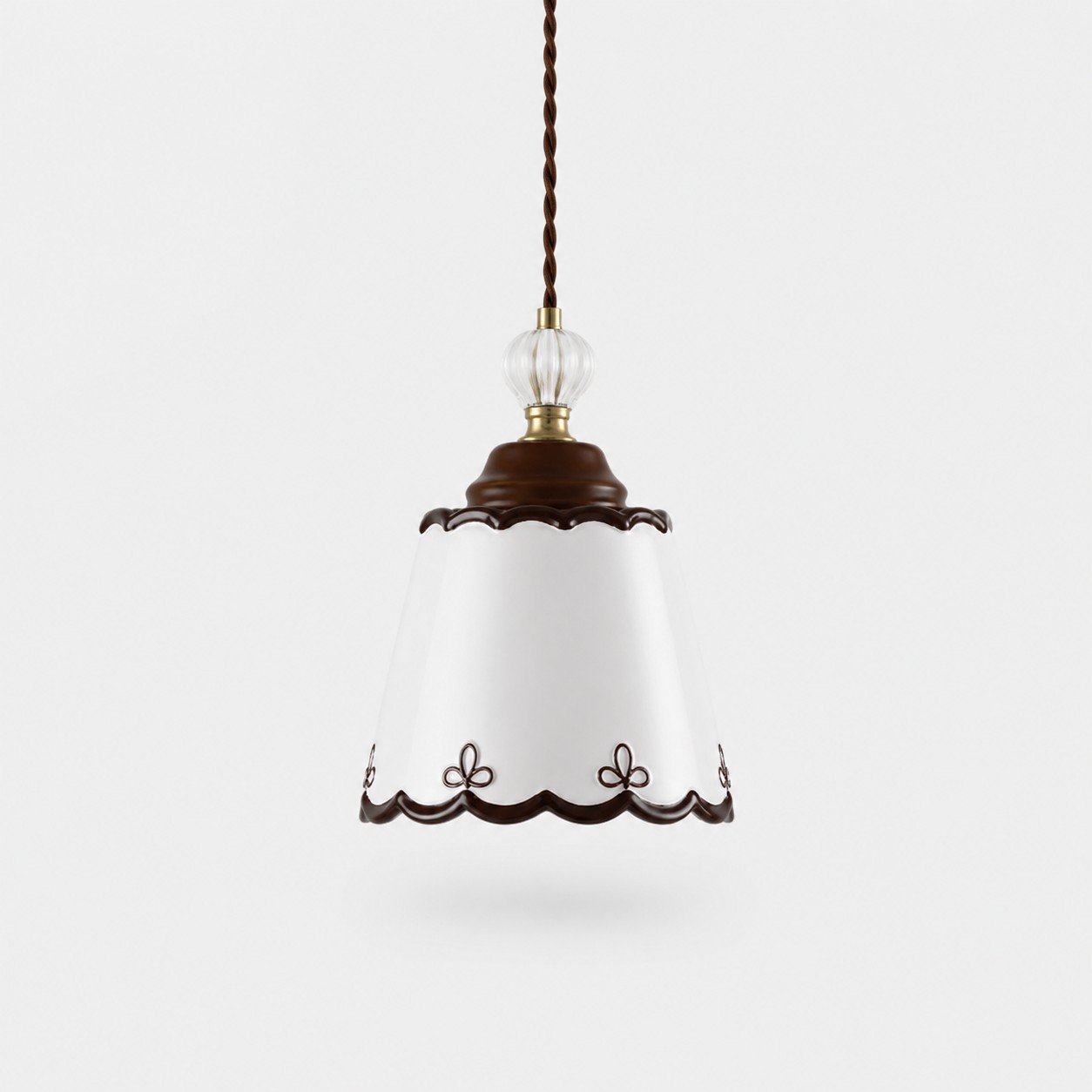 single hand-painted ceramic pendant light on a white background
