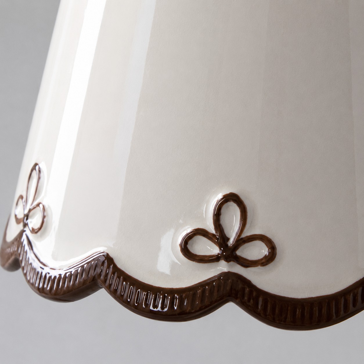 hand-painted brown floral edge on the white ceramic shade